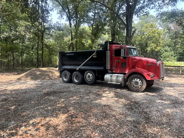 L&L dump truck hauling earth materials and removing debris in Arkansas